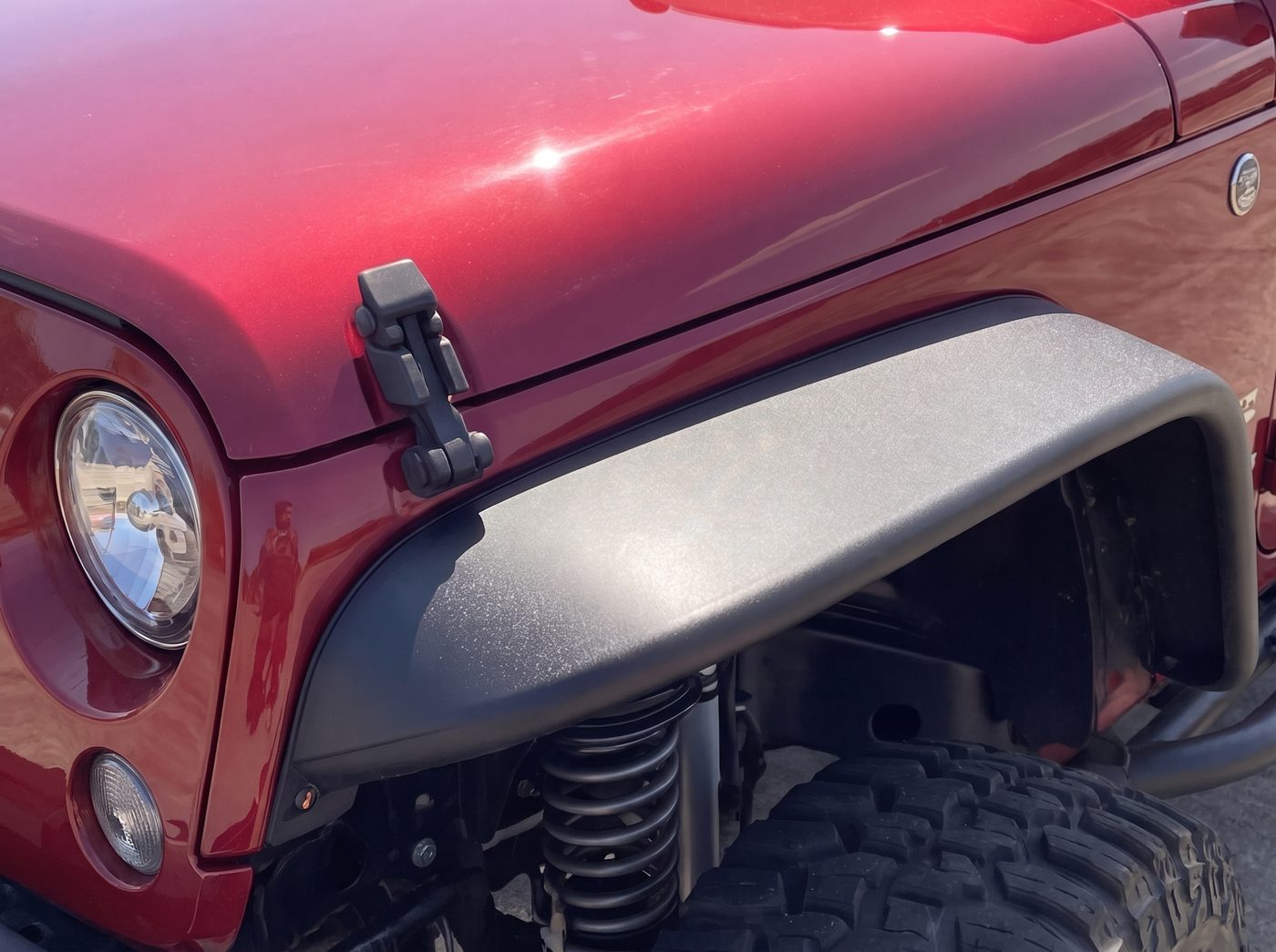 Close-up of the wheel arch and headlight in warm light